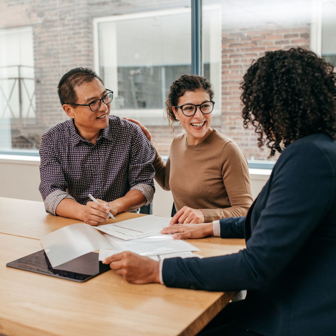 Happy couple meeting property manager