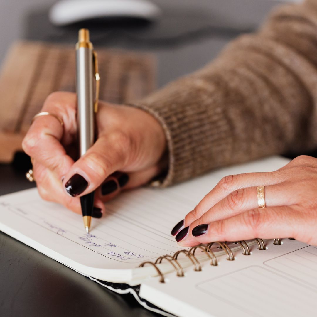 woman writing in notebook